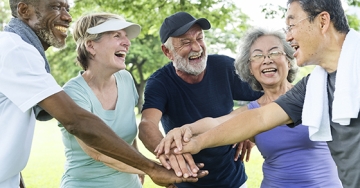 Women and men smiling and conversing