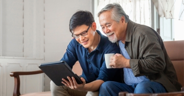 two men looking at tablet