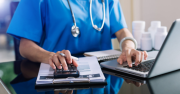 Medical professional typing on a computer