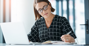 woman writing on a document