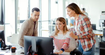 Three people looking at a computer screen