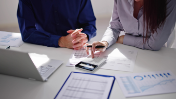 two people reviewing financial paperwork