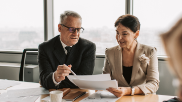 two people reviewing documents