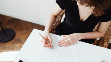 woman signing documents