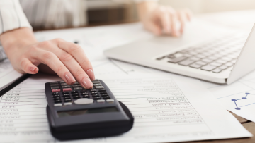 woman using laptop and calculator