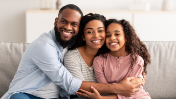 family sitting on a sofa