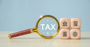 magnifying glass of the word tax