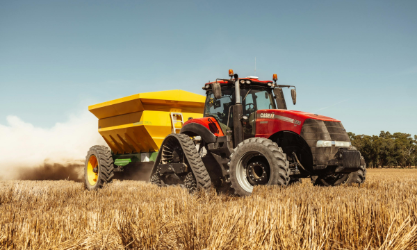 red farm tractor in a field