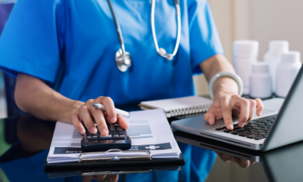 Medical professional typing on a computer