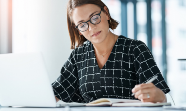 woman writing on a document