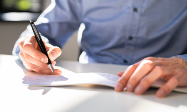 man writing a check