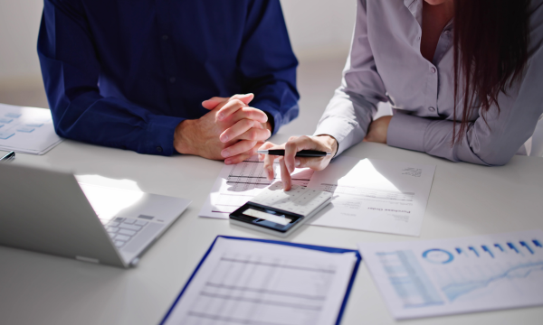 two people reviewing financial paperwork