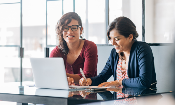 two women looking at computer