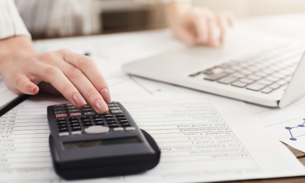 woman using laptop and calculator