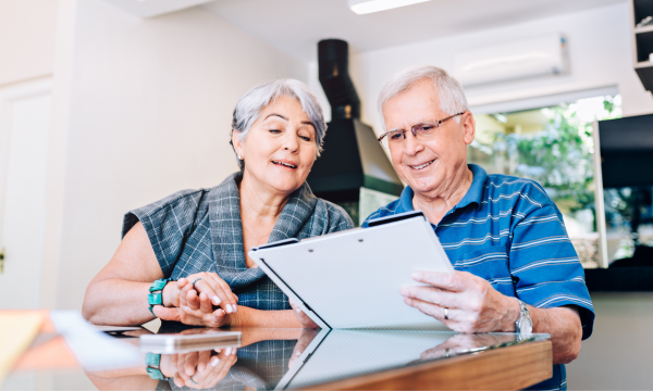 an elderly couple looking at papers