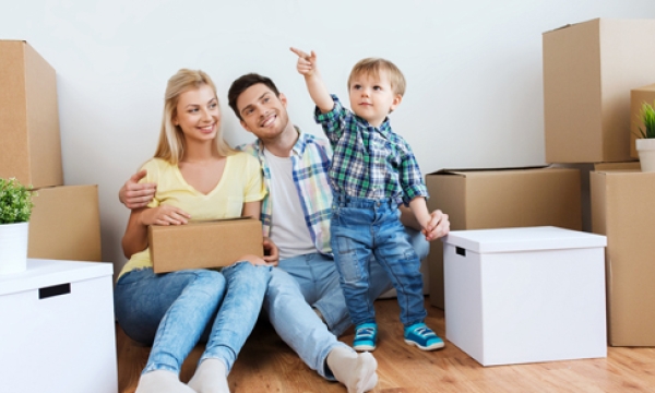 child with parents and moving boxes