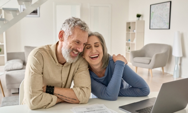happy elderly couple on laptop computer