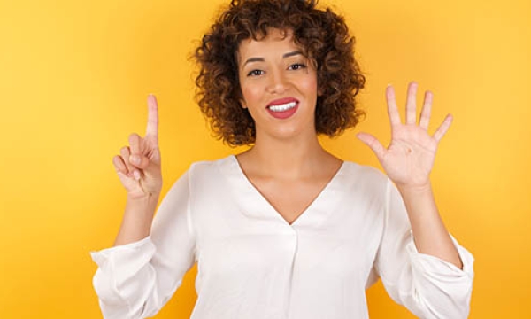 women holding up 6 fingers