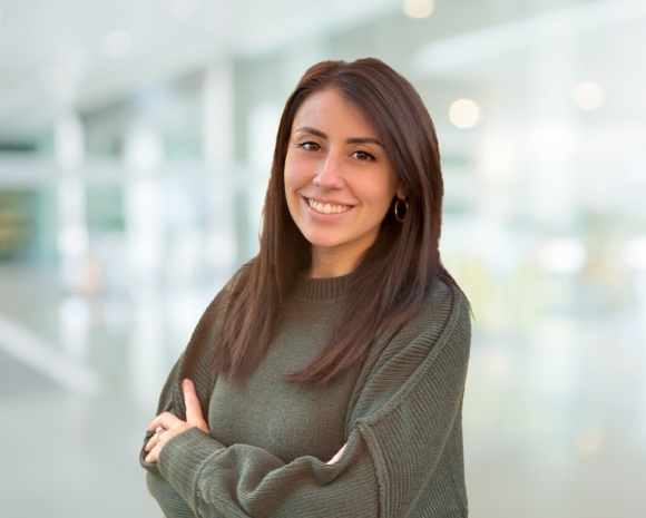 woman with brown hair wearing green sweater