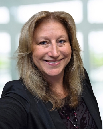 woman with blonde hair and black jacket