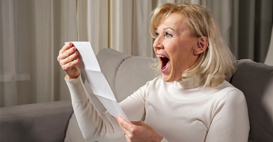 woman with receipt happy