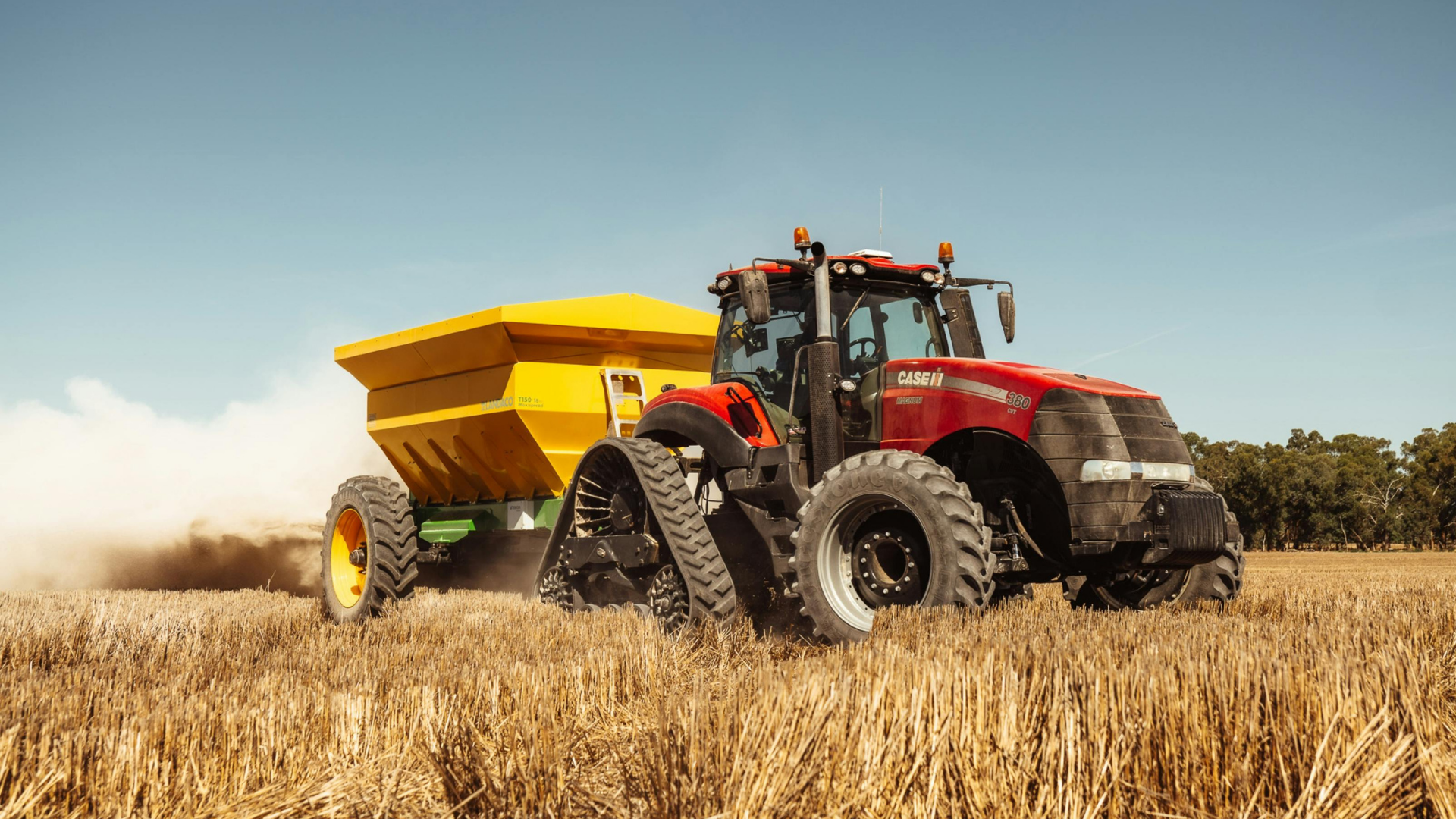 red farm tractor in a field