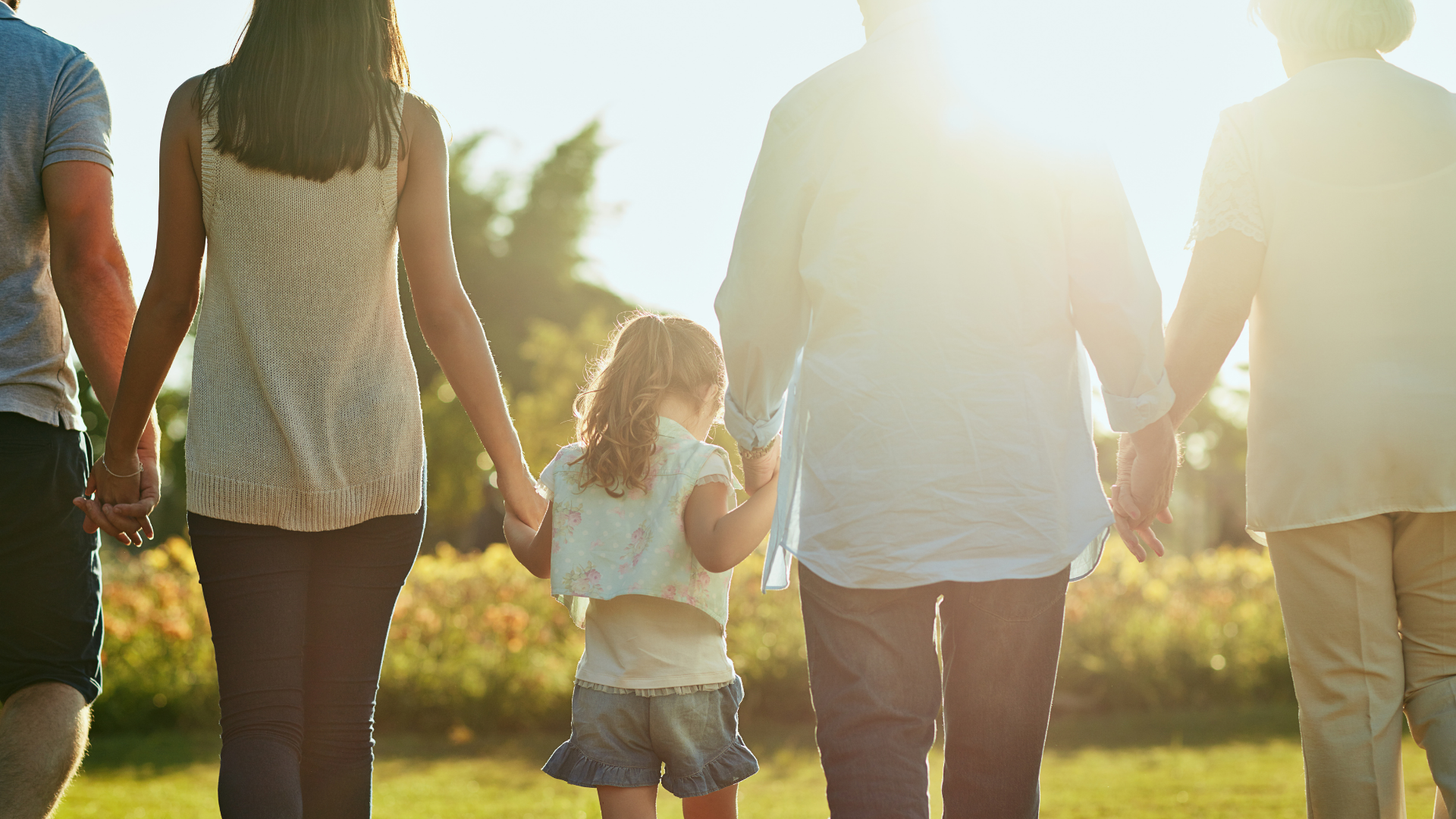 multigenerational family holding hands