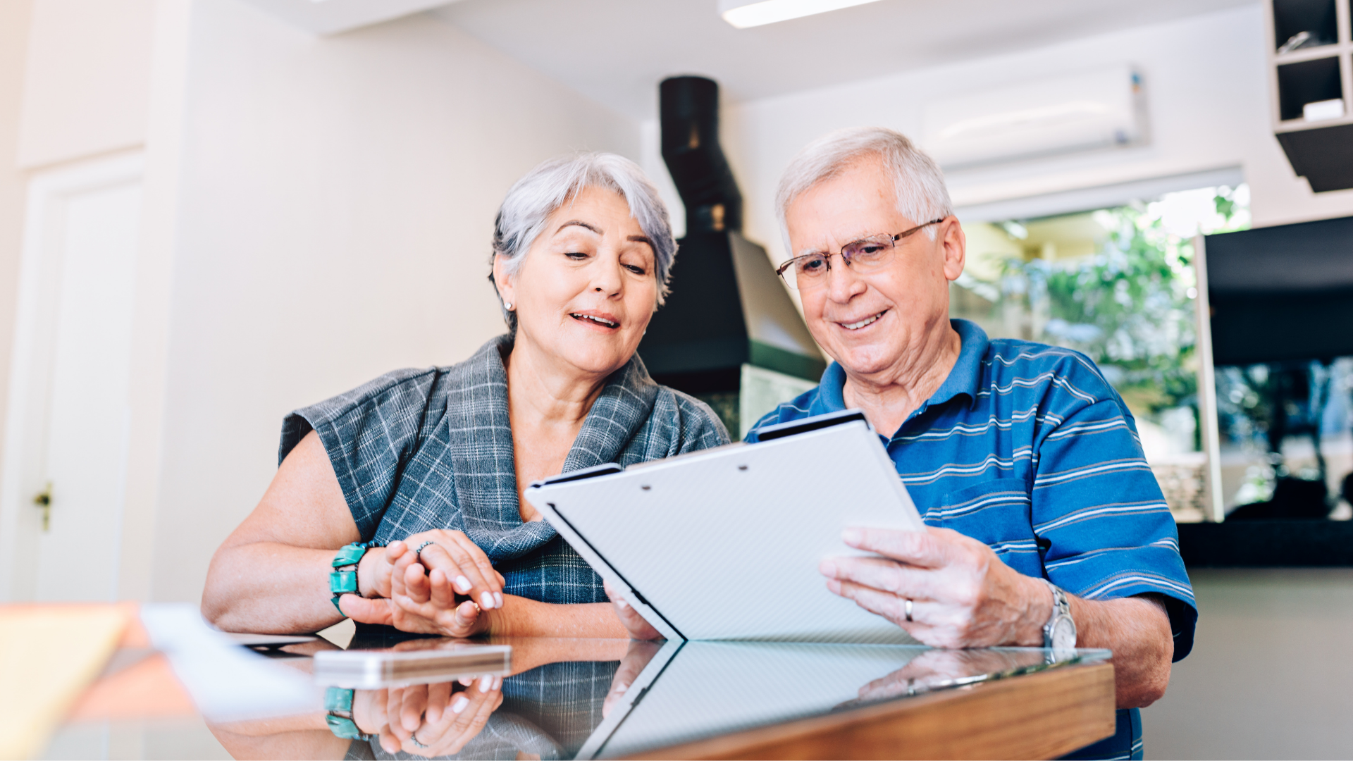 an elderly couple looking at papers