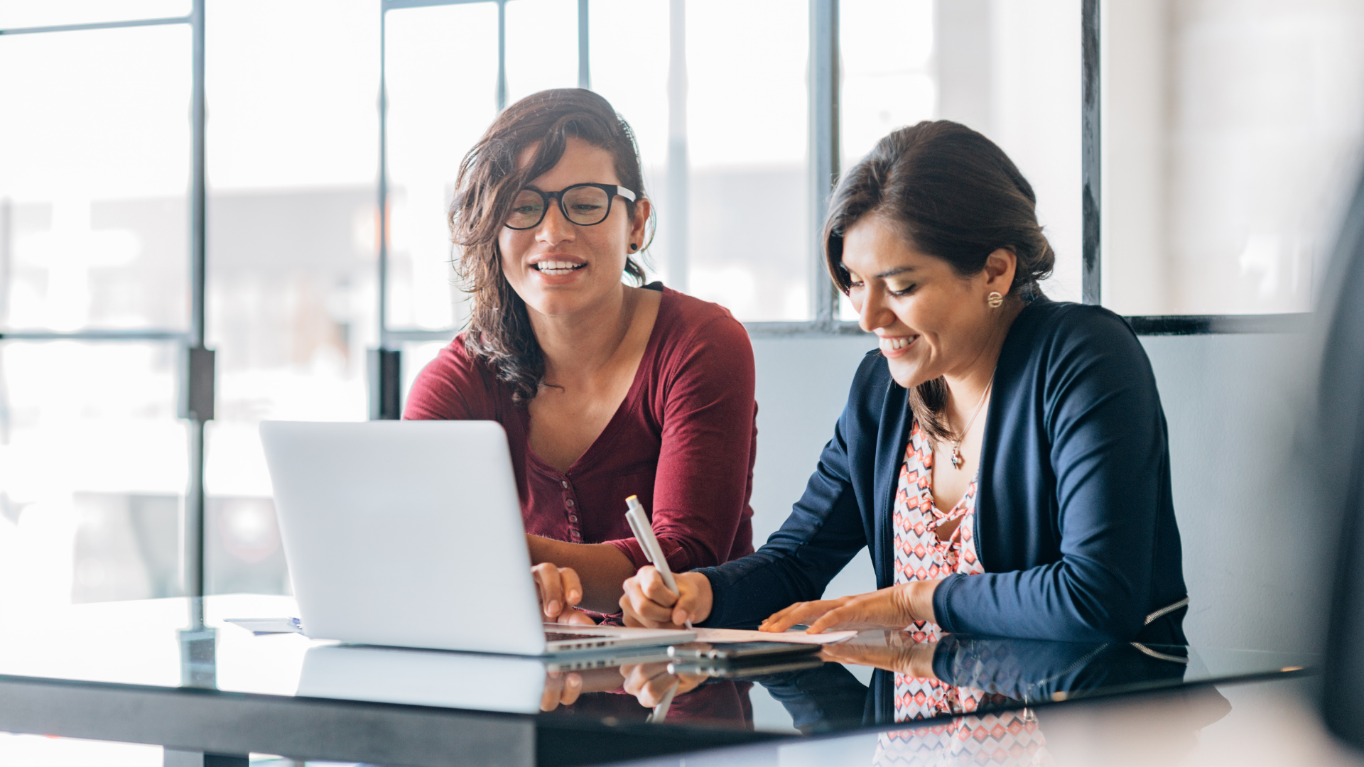 two women looking at computer