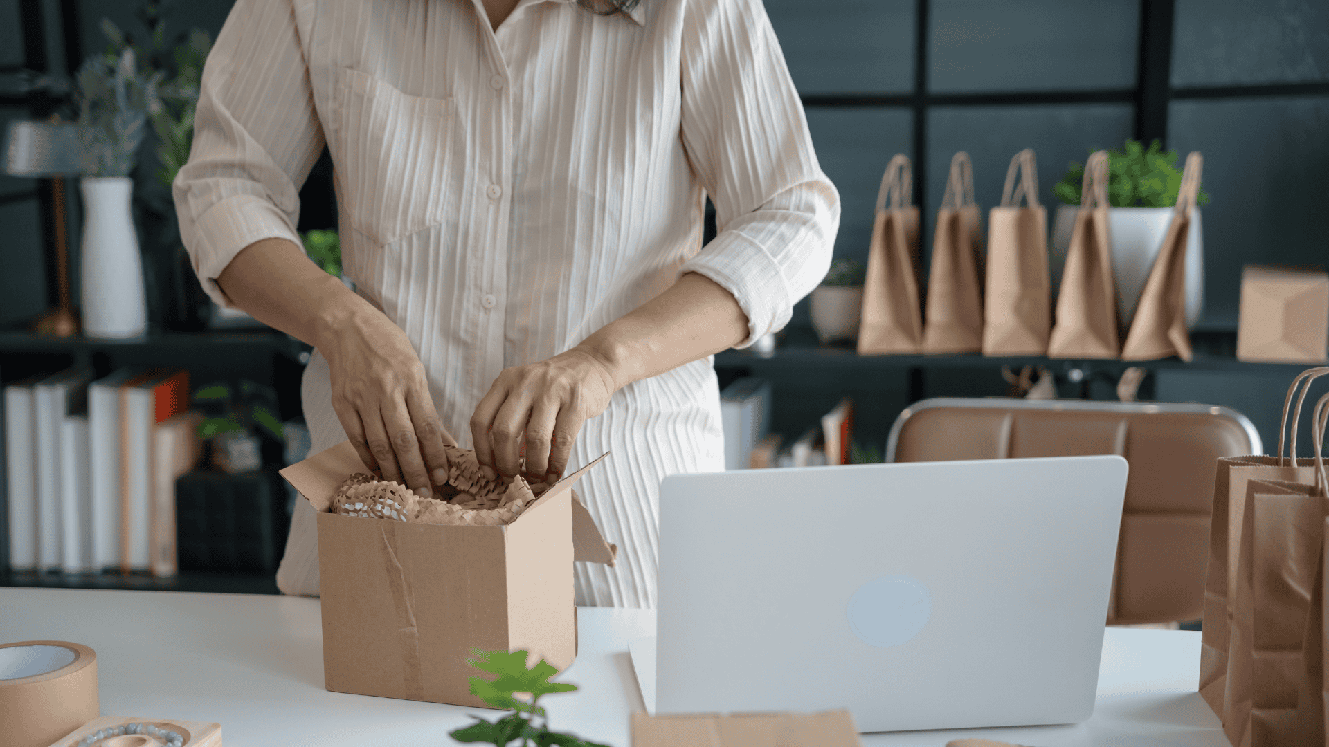 Business owner standing at a desk packing an order
