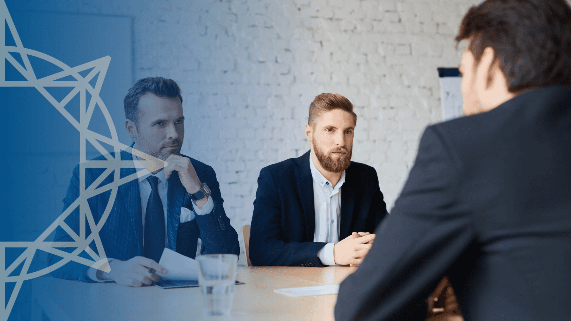 three men meeting in a conference room