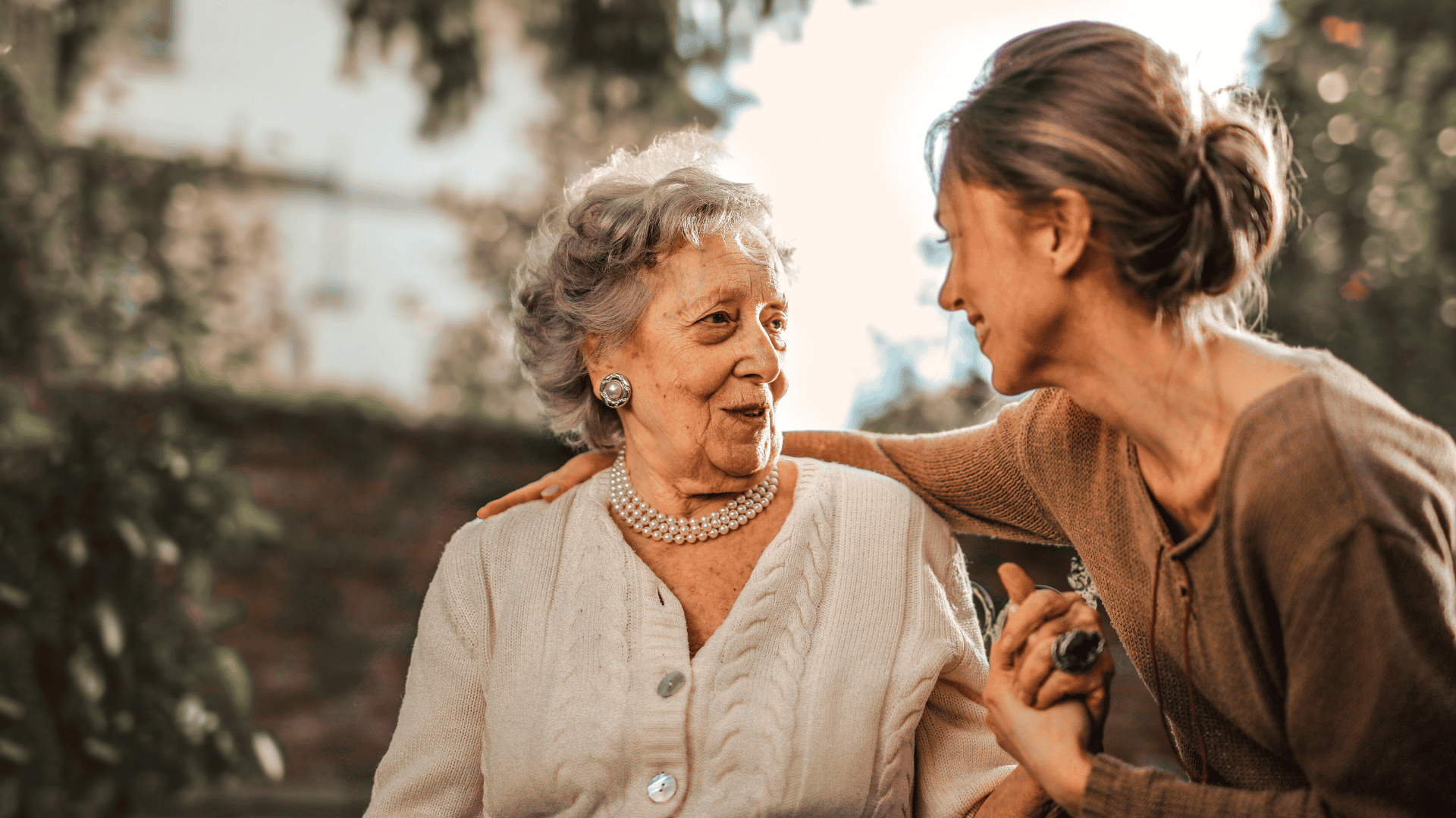 Middle aged woman and elderly woman on a bench