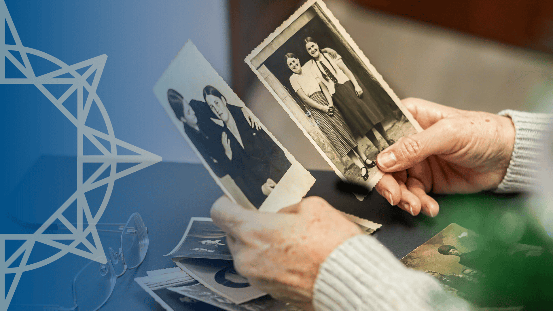 woman holding old family photographs in both hands